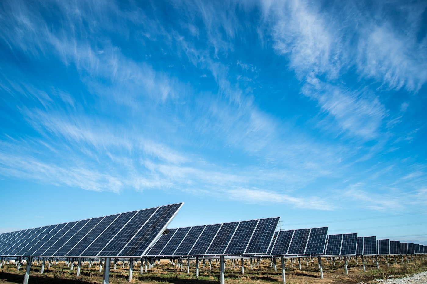 Aerial solar panel field under bright daylight